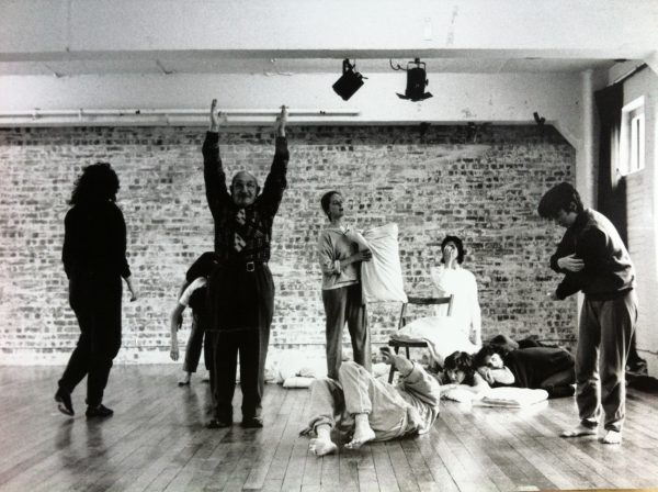a black and white photo of performers of different ages dancing. They are all busy with different unusual things.