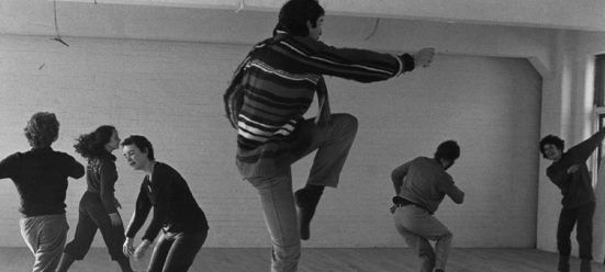 Black and white photo of a group of people dancing